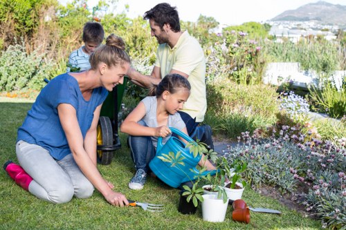 Landscapers shaping a middle-stage garden project in Boundsgreen